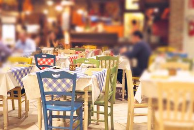 Close-up of chairs on table