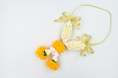 High angle view of yellow rose against white background