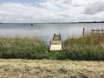 Scenic view of sea against cloudy sky