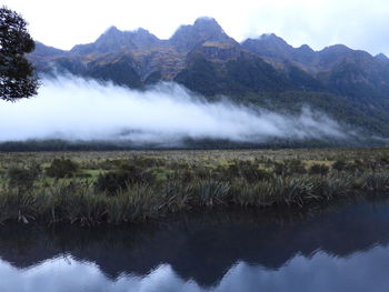Scenic view of lake and mountains against sky