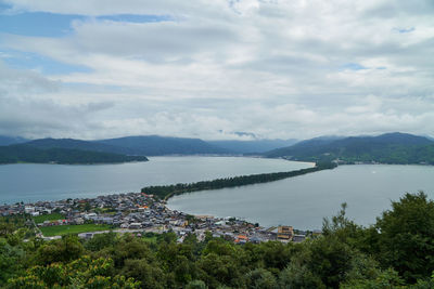 High angle view of townscape by sea against sky