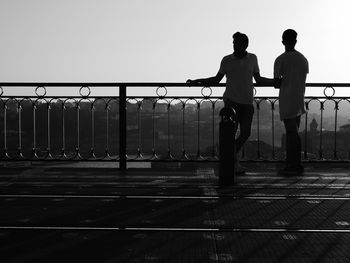 Men standing on bridge