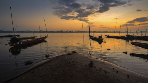 Boats in marina at sunset