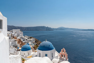 Panoramic view of sea and buildings against sky