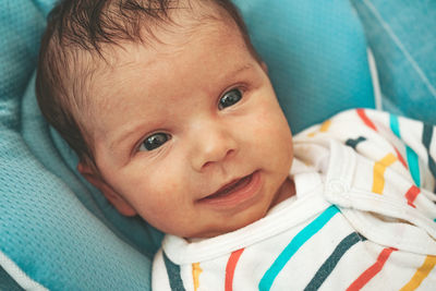 Portrait of cute baby lying on bed