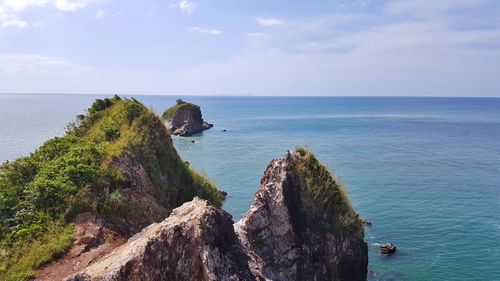 High angle view of rock formation by sea against sky