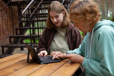 Young woman using laptop at table