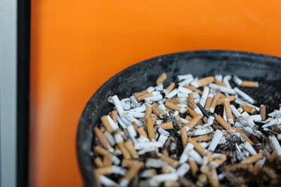 High angle view of cigarettes in ashtray on table