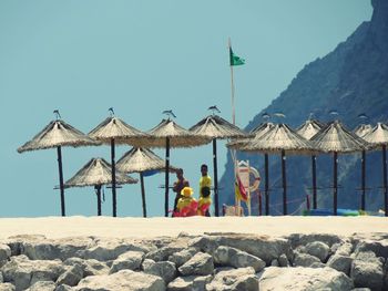 Built structure on beach against clear blue sky