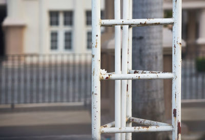 Close-up of metal fence against building