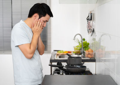 Portrait of young woman preparing food at home