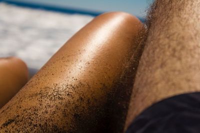 Cropped image of man and woman relaxing at beach