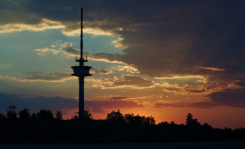 Silhouette tower against sky during sunset