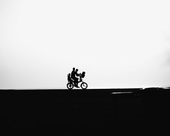 Person riding bicycle in parking lot