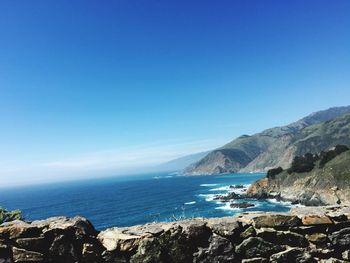 Scenic view of sea against blue sky