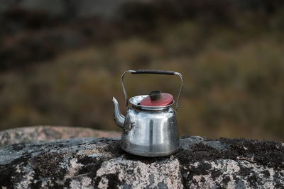 Close-up of kettle on rock