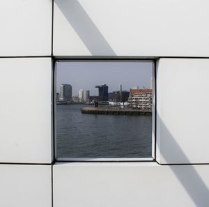 View of sea with cityscape in background