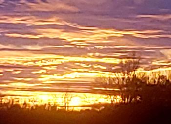 Scenic view of sea against sunset sky