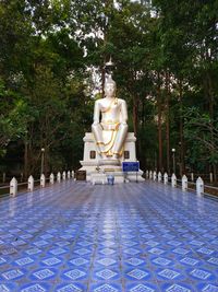 View of buddha statue against trees