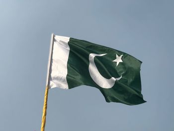 Low angle view of pakistani flag against clear sky