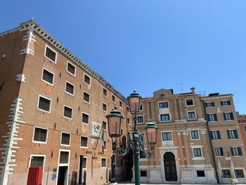 Low angle view of buildings against blue sky