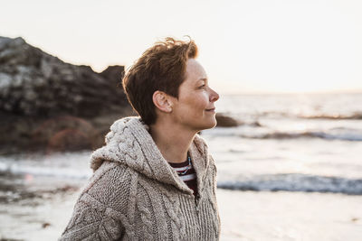 France, crozon peninsula, portrait of woman on the beach at sunset