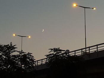 Low angle view of illuminated street light against sky