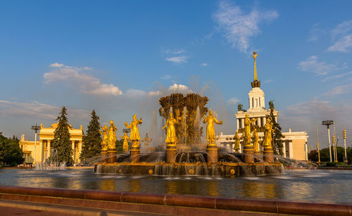 View of fountain and buildings against sky