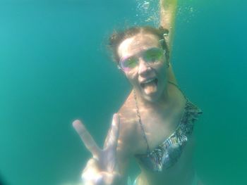 Portrait of young woman swimming in pool