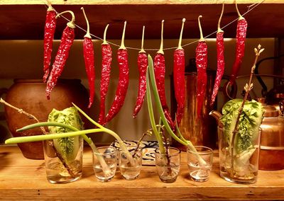 Close-up of red chili peppers hanging on table