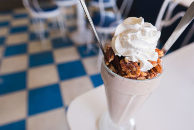 High angle view of milkshake in glass on table