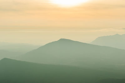 Scenic view of silhouette mountains against sky during sunset