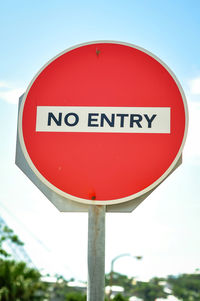 Low angle view of road sign against sky