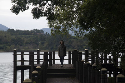 View of a woman on the wooden deck at the seaside