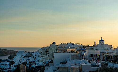 Panoramic view of oia town in santorini island with old whitewashed houses and traditional windmill