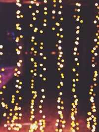 Defocused image of illuminated string lights at night