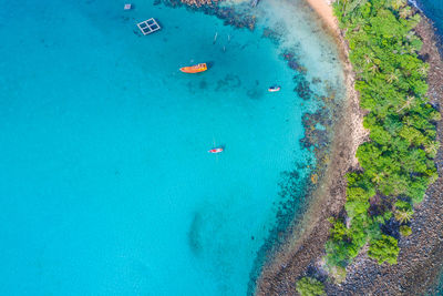 High angle view of people swimming in sea