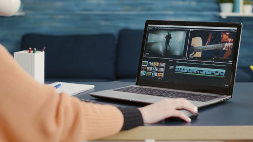 Hands of woman using laptop