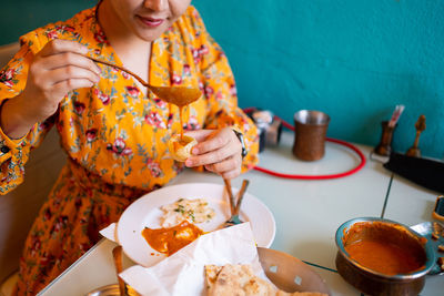 Midsection of woman having food