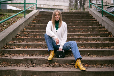 Portrait of woman sitting on staircase