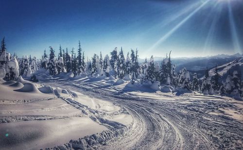 Panoramic shot of snow covered land against sky