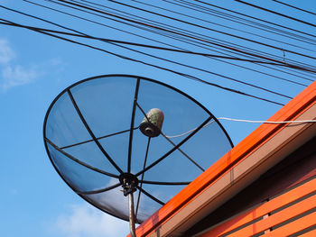 Low angle view of cables against blue sky