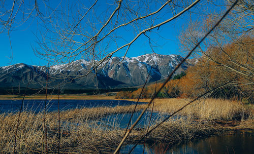 Scenic view of snowcapped mountains against clear blue sky