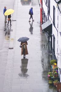 Full length of wet walking under bridge during rainy season