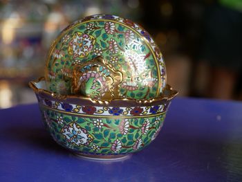 Close-up of antique container on table