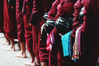 Low section of people standing in traditional clothing