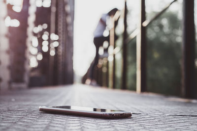 Close-up of smart phone on city street