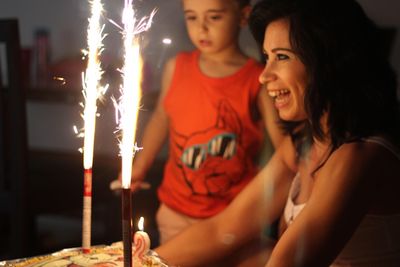 Cheerful woman looking at birthday cake