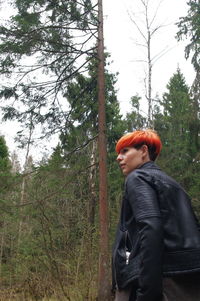 Full length of man standing by tree in forest