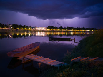 Scenic view of lake against sky at night